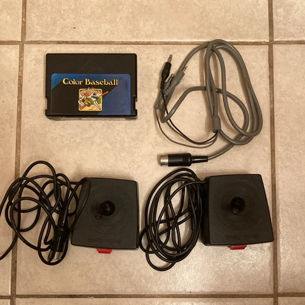 Radio Shack TRS-80 joysticks, game cable, game cartridge and Color Basic manual